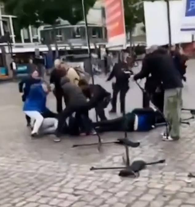 Other images captured the moment German police tackled a man to the ground after mistaking him for the attacker during a horrific stabbing spree in Mannheim, Germany.