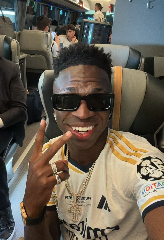 Vinicius Jnr (pictured) was one of several players who shared snaps of themselves celebrating on the team bus.