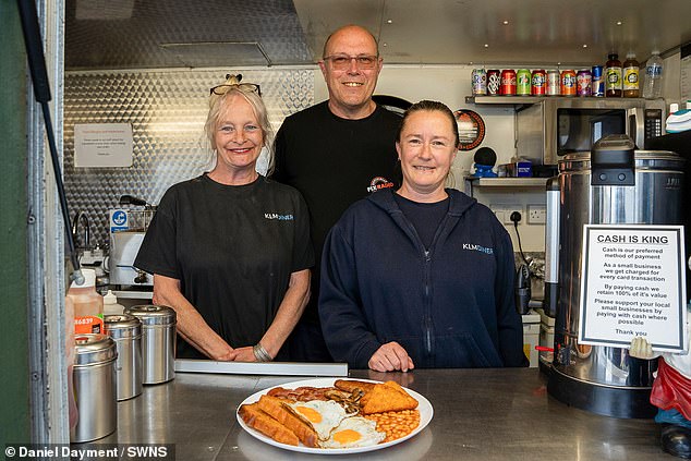 Staff at the KLM Diner in Saltash, Cornwall, proudly display one of the dishes they serve - a classic English breakfast.