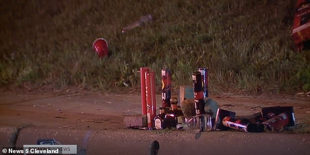 Remains of bottles and glasses are seen near the scene of the shooting early Sunday morning.