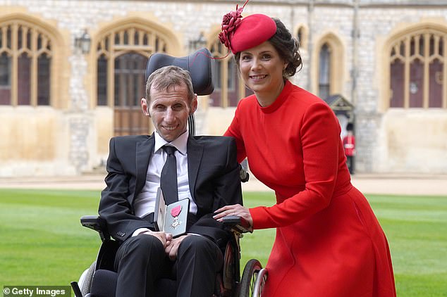 Rob with his wife Lindsey after the Princess Royal made him an MBE in 2022