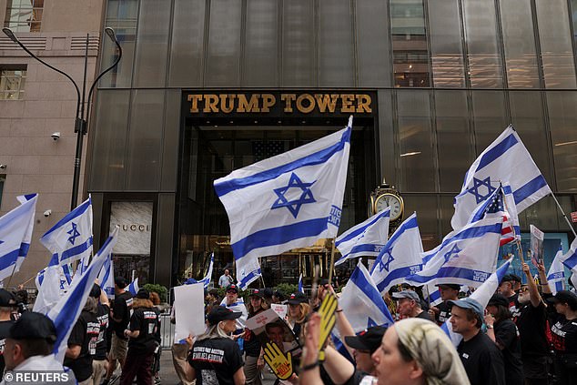 Parade-goers march past Trump Tower on Fifth Avenue