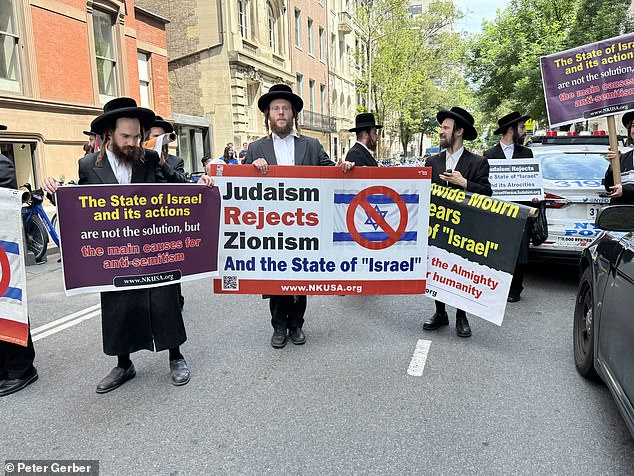 A small number of radical Hasidic Jews arrived to protest the Israel Parade; his small faction shows up most years to demonstrate.