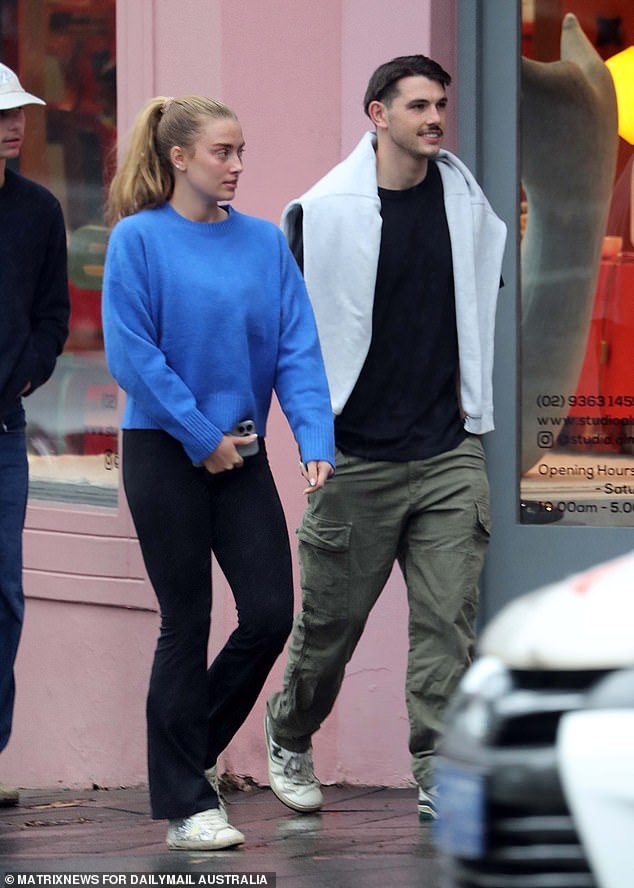 Grace dressed casually for the outing, wearing a sky blue knit sweater, black flared leggings, and white sneakers.