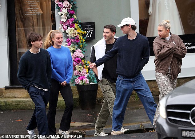 The couple was all smiles as they laughed and chatted with a small group of close friends.