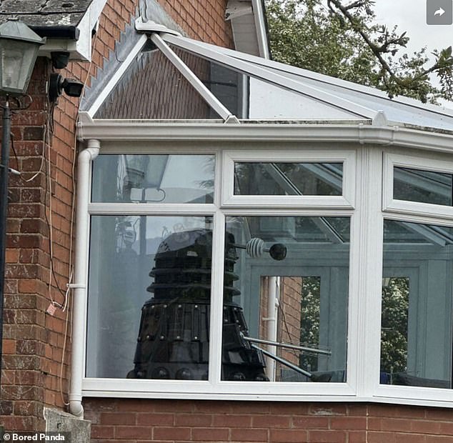 Passing by their neighbors' greenhouse, one person saw a Dalek spying on intruders among the living.