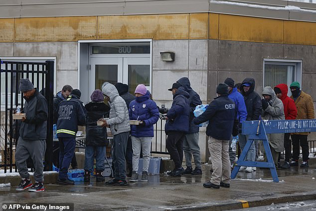 Newly arrived migrants in Chicago receive food during winter storm