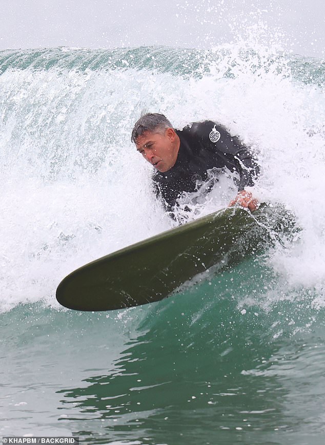 Looking completely at ease among the crashing waves, Jamie was left completely soaked as he dove and surfed through the salt water.