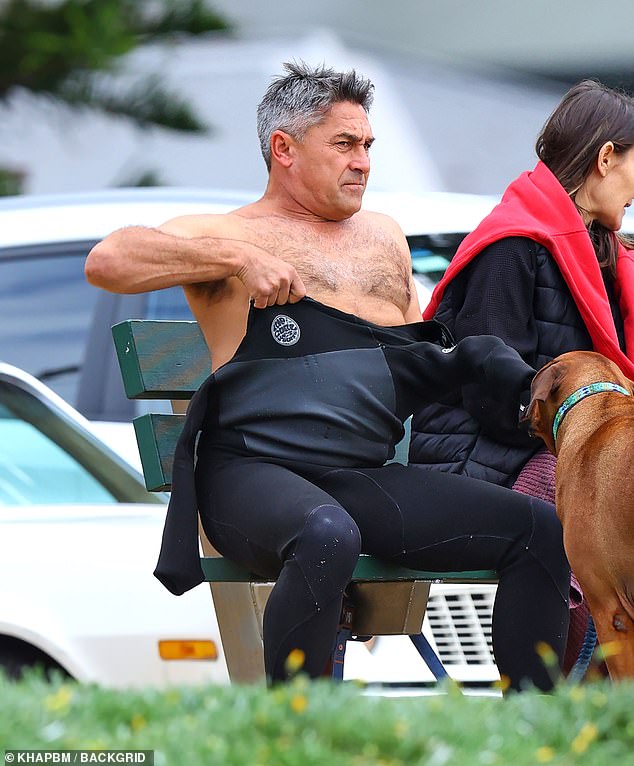 Once Jamie was in the water, he could be seen trying to remove his saturated black wetsuit as he sat on a nearby park bench.