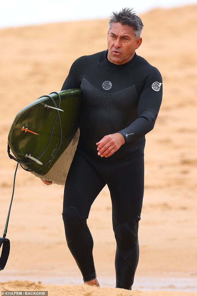 Jamie arrived at the beach with a huge green surfboard under his arm.