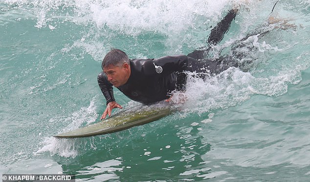 He paddled hard through the water before trying to get up.