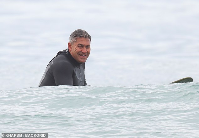 He could barely wipe the smile off his face after successfully surfing a wave.