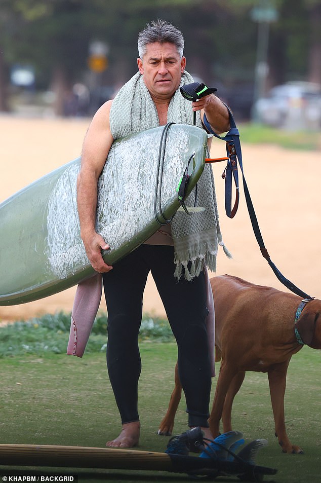 Jamie then put a towel around his neck as he packed up his surfboards.