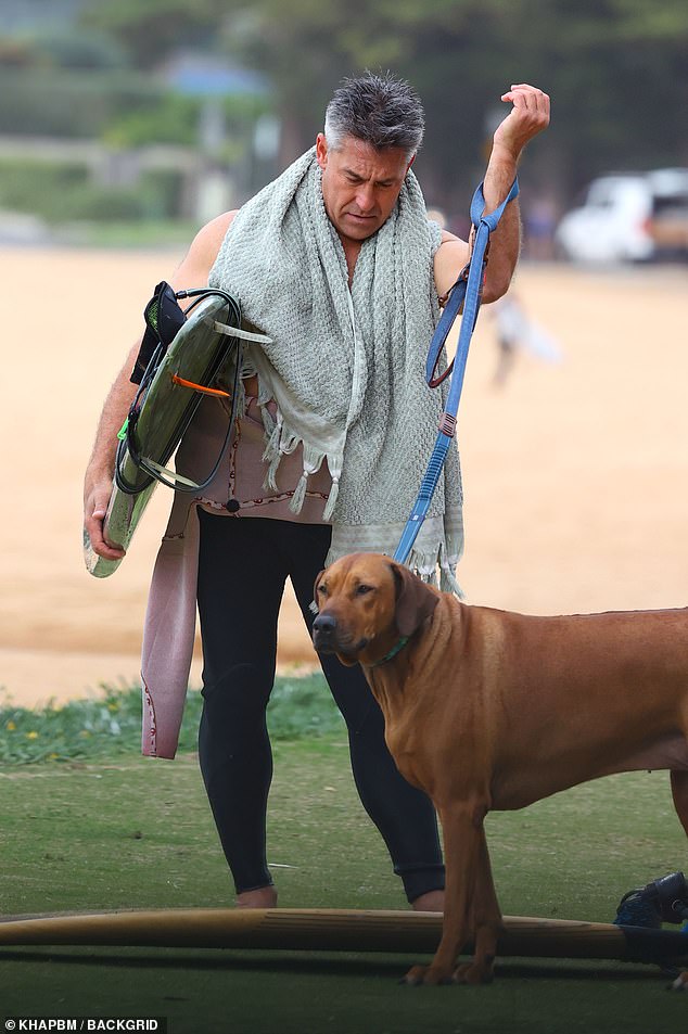 The dogs were on their best behavior while Jamie juggled their leashes with his board.