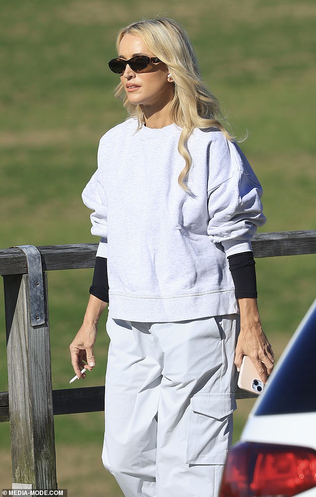 Jackie kept her eyes protected from the sun with a pair of designer sunglasses.