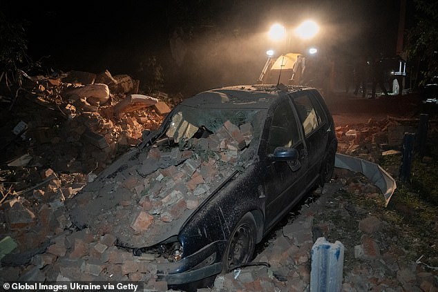 Damaged car lies in rubble after Russian missile attack on May 31, 2024 in Kharkiv, Ukraine