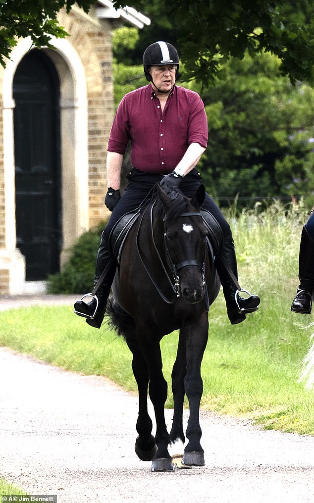 The duke was seen wearing a burgundy shirt, black trousers and riding boots as he took a walk around the grounds.