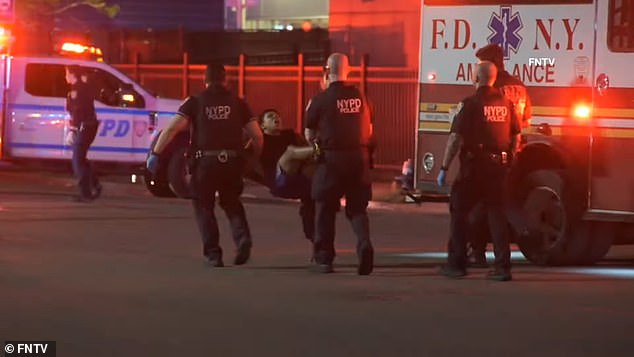 Another image shows three officers carrying Castro-Mata away from the crime scene in East Elmhurts, Queens, by his arms and legs while he grimaces.