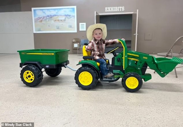 Levi ran away from his family on the toy tractor (pictured) and his mother dove into the river to save him after he disappeared under the currents.