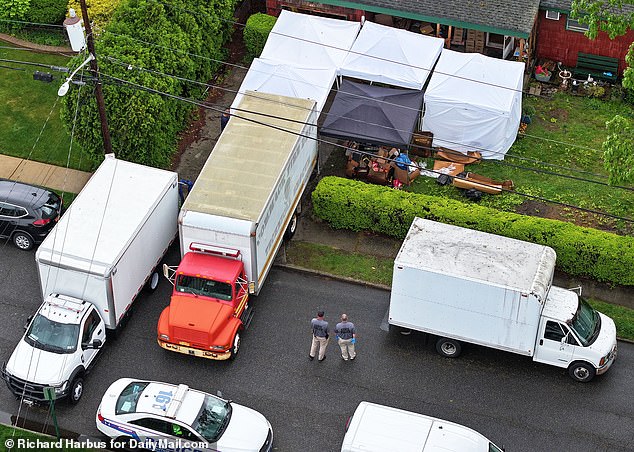 The larger truck with the red front engine is where they loaded the family's possessions to clean rooms and conduct more searches and the white box truck is a real evidence truck that returns to the crime lab for testing.