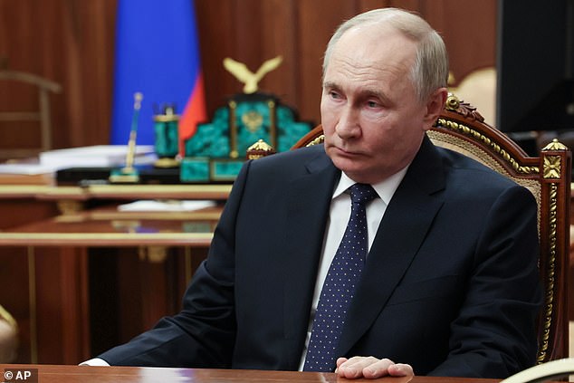 Russian President Vladimir Putin (pictured) listens to Archpriest and Chairman of the Board of Directors of the Circle of Kindness Foundation Alexander Tkachenko during their meeting in the Kremlin.