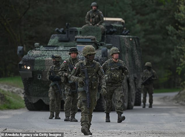 Polish soldiers before a high-intensity training session with M1A2 Abrams tanks at the Nowa Deba training ground, May 6, 2023.