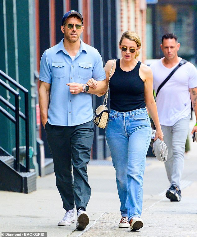 Ryan wore a blue short-sleeved shirt with gray pants and white Converse sneakers, while Blake wore a black tank top tucked into blue jeans with red Converse sneakers.