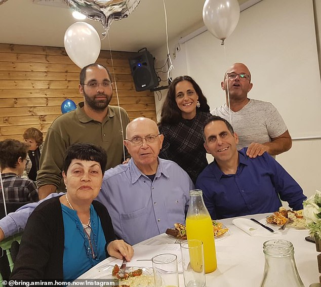 Amiram and Nurit photographed with their son, Rotem, sitting next to his father.