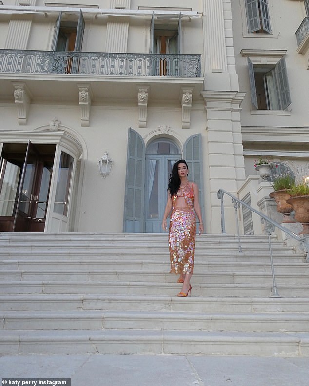 She also donned a sheer sequined top, which showed off her toned midriff, and the matching midi skirt over her swimsuit for close-up photos outside the hotel.