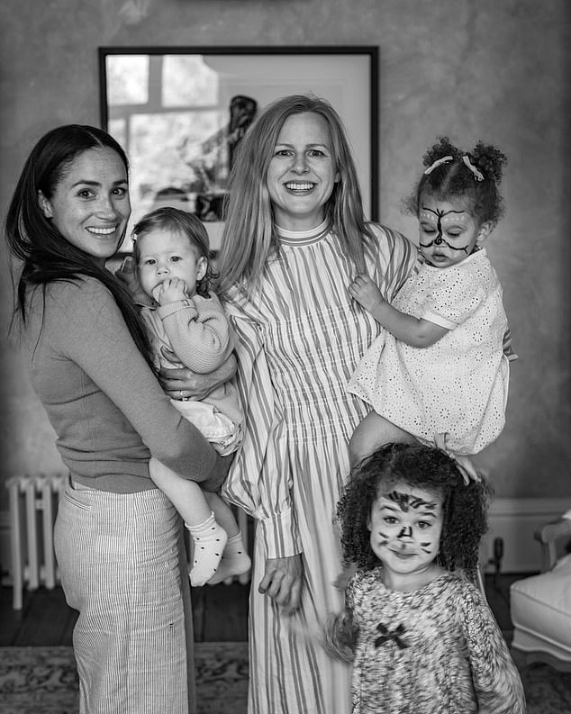 Photos shared by the Sussexes' friend and professional photographer Misan Harriman include a snap of Meghan holding Lilibet while with the photographer's wife, Camilla Holmstroem, and their two daughters on Lilibet's first birthday.