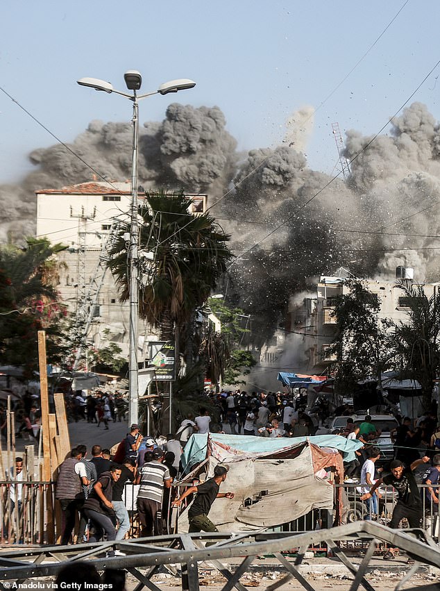 Smoke rises from Al-Magahazi building bombed during Israeli attacks on Al Bureij camp