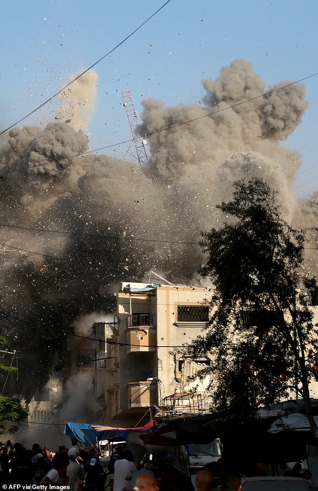 Dust and debris fall from residential building targeted by Israeli airstrike