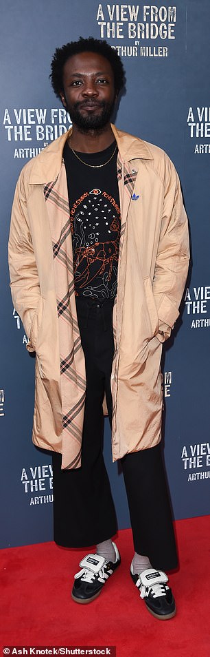 It's A Sin star Omari Douglas kept cool in an oversized beige trench coat