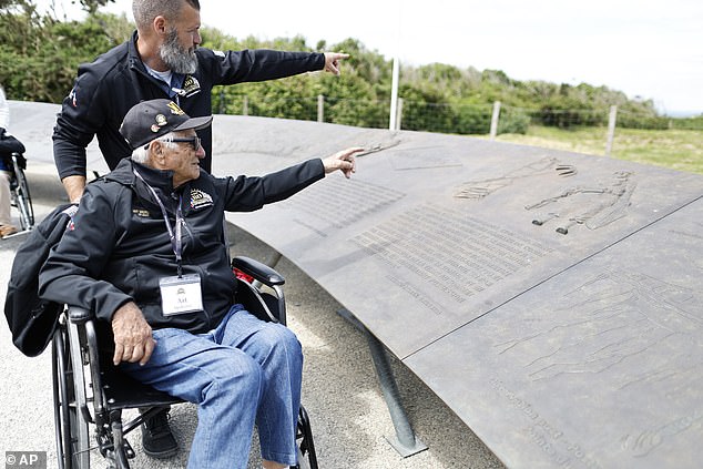 Veteran Art Medeiros, among 60 surviving D-Day heroes who were flown to Normandy for the tribute, points to the ocean at the event.