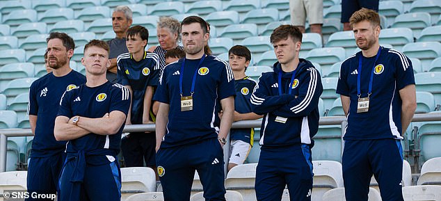 A somber-looking Doak (second right) watched from the stands as Scotland beat Gibraltar.