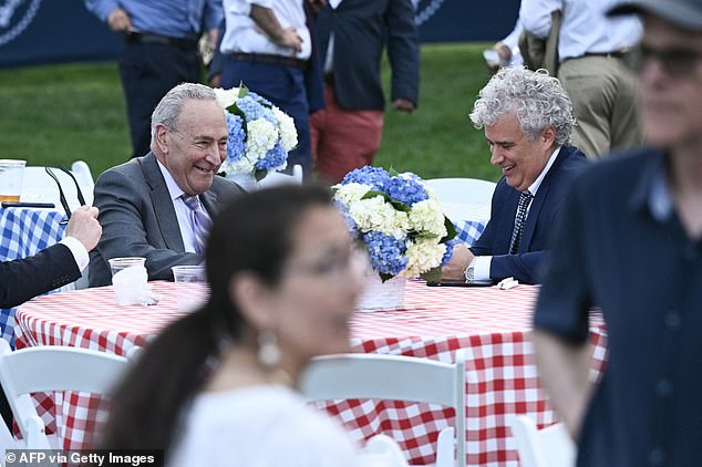 Biden briefly acknowledged Majority Leader Sen. Chuck Schumer (D-NY), sitting with White House Chief of Staff Jeff Zients (R).