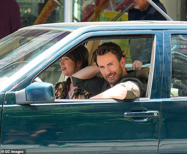 Chris rolled down the window and smiled at the camera as the couple sat in the front seats filming their romantic comedy.