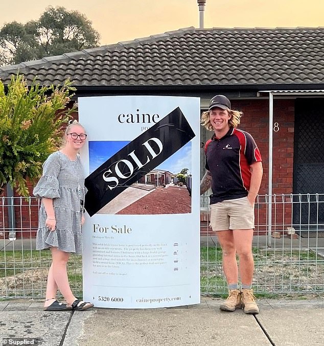 Ms McGuire had bought a house with Young just under a year before he allegedly murdered her (the former couple is pictured posing outside the house)