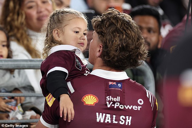 Walsh's young daughter Leila was in the crowd, and the defender recovered well enough to find and comfort her while the game was still going on (pictured).