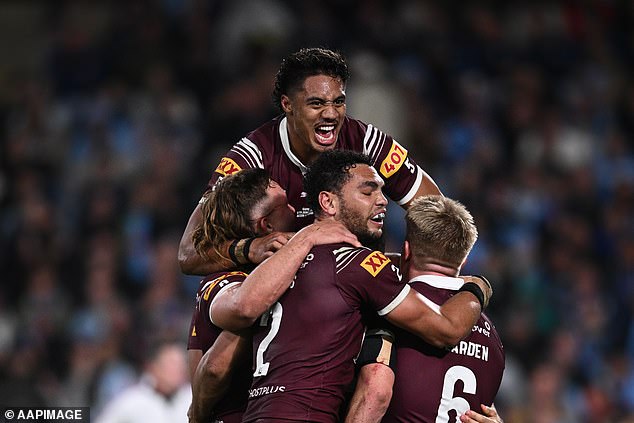 Murray Taulagi (above) leads the celebrations after the Maroons crushed the Blues, who now must win two away games to regain the shield.