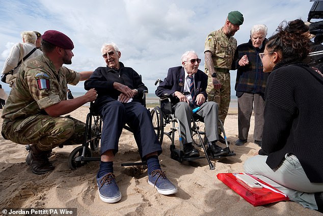 Corporal Aaron Stone, veterans John Life and Donald Jones are pictured yesterday after returning to Sword Beach in Normandy, France, where they landed on D-Day.