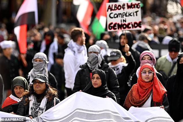 Protesters march during a pro-Palestinian demonstration outside State Library Victoria in Melbourne, Sunday, June 2, 2024.