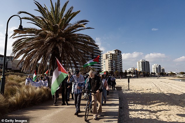 Pro-Palestinian supporters march along Port Melbourne beach during a 'national day of action' on May 25, 2024.