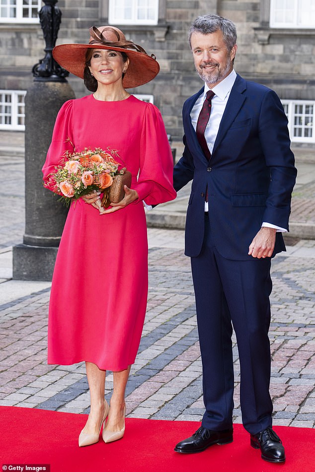 Frederik put his arm around Maria as she smiled for photographs in front of Holmen Church in central Copenhagen.