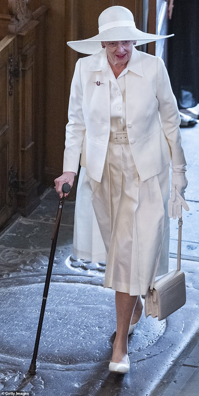 The former monarch, 84, looked elegant in an all-white ensemble and matching wide-brimmed hat.