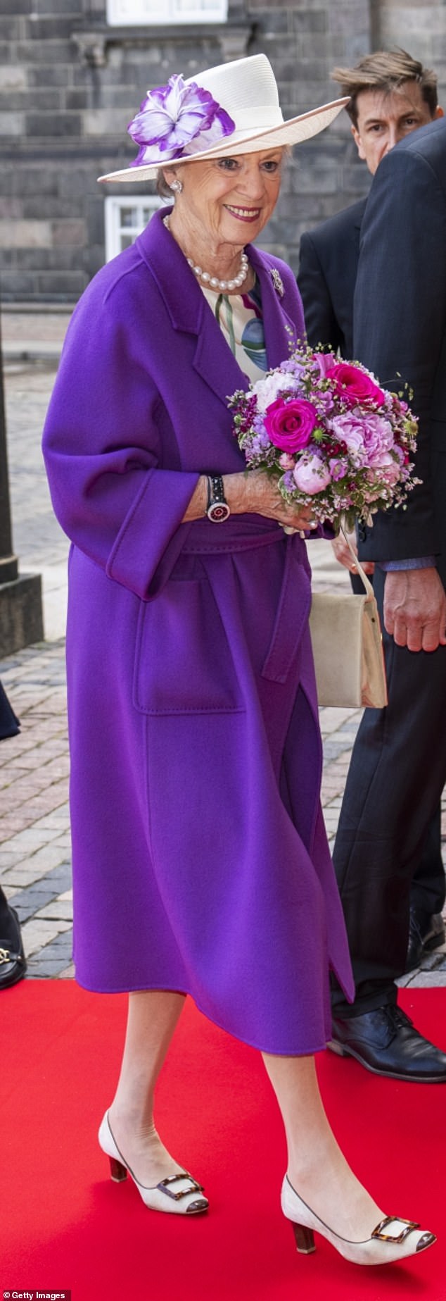 Princess Benedikte put on an elegant show in a purple coat and an off-white floral-print dress.