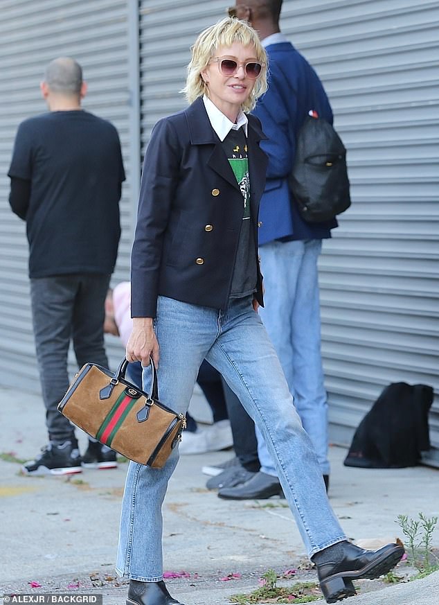 Portia gave a masterclass in preppy style in a crisp white shirt with a navy and green sweater, a navy jacket and perfectly distressed straight-leg jeans.