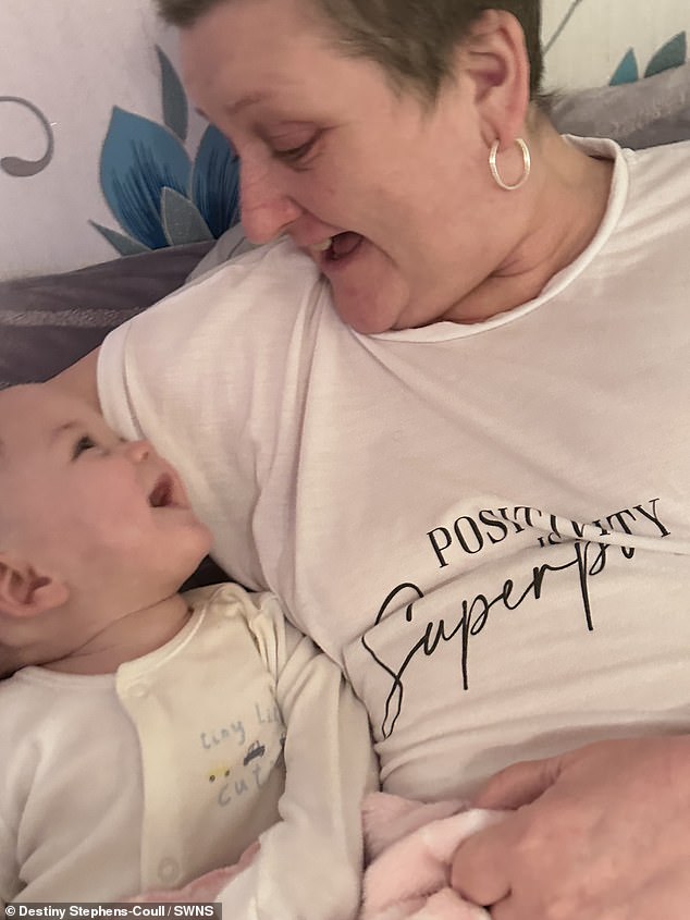 The little one's grandmother, Diane, pictured hugging her new grandson.