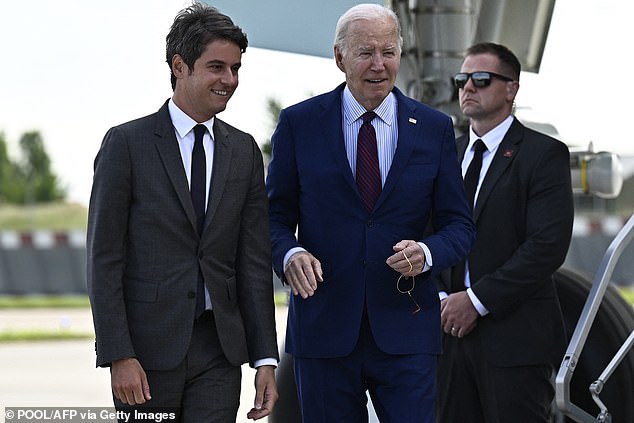 US President Joe Biden (center) is greeted by French Prime Minister Gabriel Attal upon arrival at Orly airport near Paris on June 5.