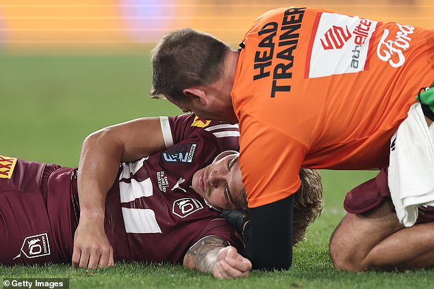 Walsh's shoulder to the jaw momentarily knocked him out (pictured) and he played no further part in Queensland's 38-10 victory.